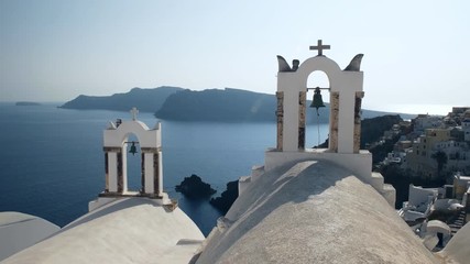 Wall Mural - afternoon shot of two church bells in the village of oia on the island of santorini, greece