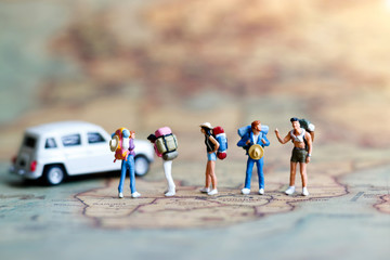 miniature backpacker on map with car, concept of travel around the world and the adventure.