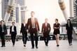© khwanchai - Teamwork and professional partnership concept, businesspeople team of multi ethnic walking with confidence in full suit.