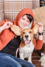 Young Smiling Girl With Happy And Silly Beagle Dog Who Shows The Tongue