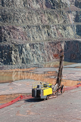 Wall Mural - driller machine in a quarry mine. open pit.