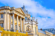 View of the beautiful facade of the Palace of Versailles in a bright sunny day