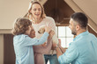© LIGHTFIELD STUDIOS - family with adorable labrador puppy in front of cardboard house