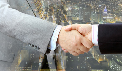 Aufkleber - Closeup of business people handshake on big city at night background 