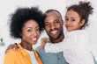 © LIGHTFIELD STUDIOS - smiling african american family looking at camera