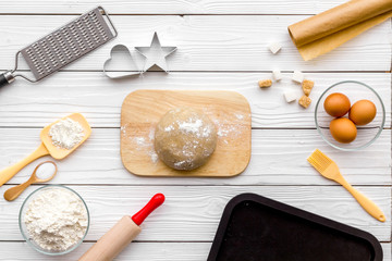 Roll out the dough. Dough ball near roller pin and other cookware on white wooden background top view