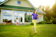 © MNStudio - Cute little girl having fun on a grass on the backyard on sunny summer evening