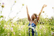 © Inti St Clair/Blend Images - Smiling mixed race woman celebrating in field of wildflowers