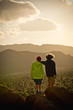 © Stephen Simpson Inc/Blend Images - Boys standing on rock admiring desert landscape