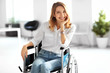 © Africa Studio - Young woman in wheelchair at workplace