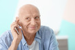 Hearing impaired man talking on phone at home
