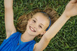 © Inti St Clair/Blend Images - Close up portrait of smiling Caucasian girl laying on grass