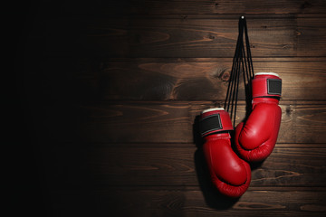 Wall Mural - Boxing gloves on wooden background