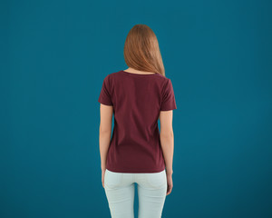 Wall Mural - Young woman in stylish t-shirt on color background. Mockup for design