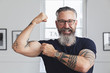 © Strauss/Curtis/Blend Images - Close up of smiling muscular Caucasian hipster man flexing biceps