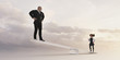 © Donald Iain Smith/Blend Images - Girl on seesaw lifting businessman