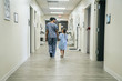 © FS Productions/Blend Images - Nurse walking with girl in hospital corridor