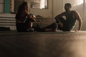 Wall Mural - Couple taking break after training session at gym