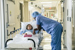 © FS Productions/Blend Images - Doctor holding hand of girl in hospital gurney