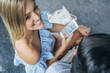 © Inti St Clair/Blend Images - Smiling Caucasian woman texting on cell phone near man