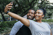 © Inti St Clair/Blend Images - Smiling Black couple posing for cell phone selfie