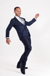 Businessman in a suit dances.
White background.
Isolated image.