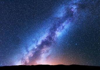Wall Mural - milky way. fantastic night landscape with bright milky way, sky full of stars, yellow light and hill