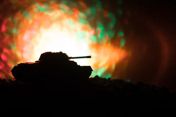 War Concept. Military silhouettes fighting scene on war fog sky background, World War German Tanks Silhouettes Below Cloudy Skyline At night. Armored vehicles. Tanks battle