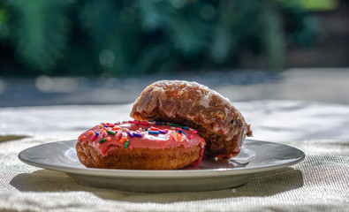 Two donuts outside in natural light