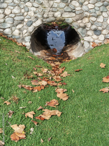 Fotografia, Obraz Culvert with water under stone structure