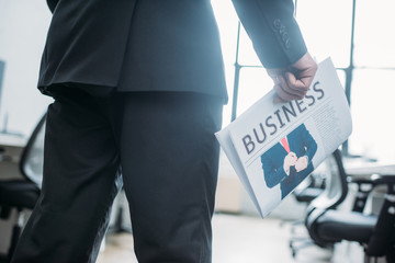 Wall Mural - partial view of businessman with newspaper in hand in office