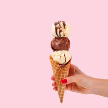 Chocolate And Vanilla Ice Cream Cone On White Background.