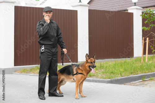 Obraz na plátně Security guard with dog, outdoors