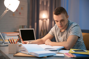 Canvas Print - Student doing homework indoors late at night