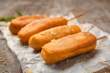 Wall Mural - Tasty corn dogs on table, closeup