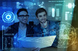 © zinkevych - Double check. Cheerful young it men sitting at the table while programming together at night