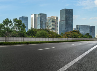 Wall Mural - empty asphalt road front of modern buildings.