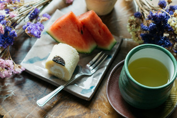 Food and drinks series: Tea break with roll cake and hot green tea