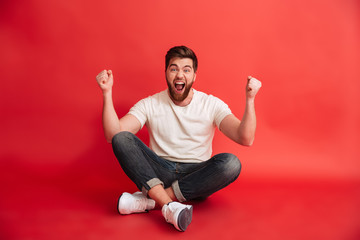 Sticker - Emotional bearded man showing winner gesture.