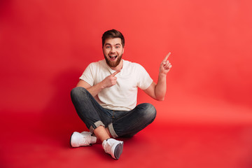 Poster - Smiling bearded man pointing.