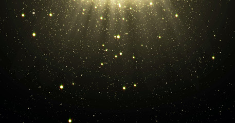 abstract gold glitter particles background with shining stars falling down and light flare or glare 