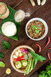 © Suntipong - Oxtail soup in white dish on brown wood, Delicious Esan Thai food, Isan food