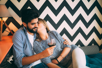 Wall Mural - Couple in cafe drinking red wine.