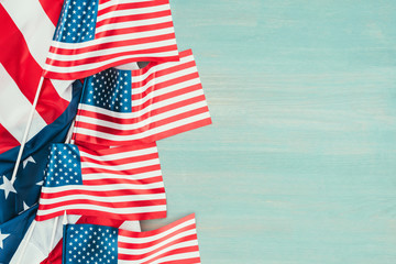 top view of arranged american flags on blue wooden tabletop, presidents day concept