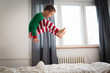 little boy jumping on bed in bedroom