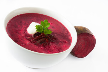 Beet soup in white bowl isolated on white background

