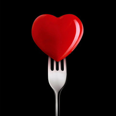 Wall Mural - red heart close up on a black background.