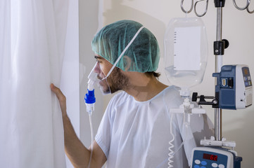 young man in a hospital, wearing an oxygen mask