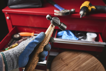 Wall Mural - a worker holding a wood and steel hammer.