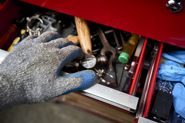 Wall Mural - a mechanic opening a draw of tools